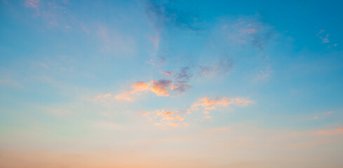 Naklejka na ściany i meble Sunrise clear blue sky with glowing pink clouds at sunset.Blue orange cloudscape