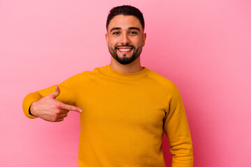 Young mixed race man isolated on pink background