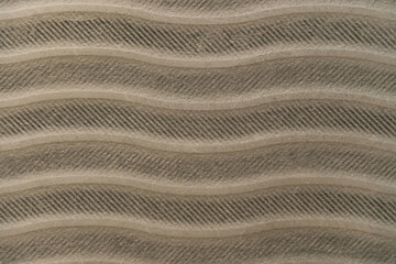 grey, cement textured surface, with horizontal wavy lines, top view