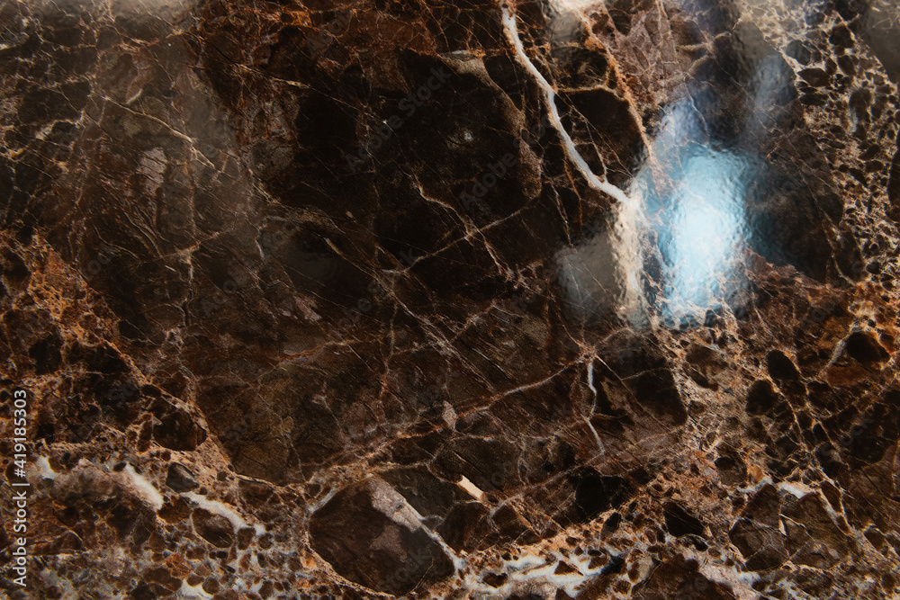 Sticker background of dark, marble glossy stone with streaks, top view