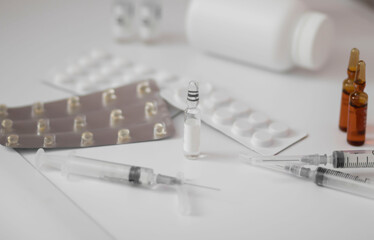 Medications. Ampoule of a medical syringe isolated on a white background. Pills.