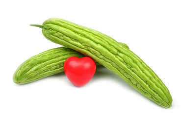 Fresh bitter gourd with a red heart on a white background.	