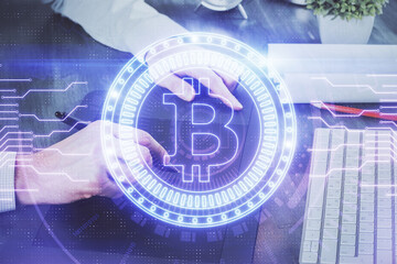 Double exposure of man's hands holding and using a phone and crypto currency blockchain theme drawing.