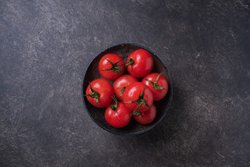 Red, fresh, ripe tomatoes with water drops. Collecting tomatoes. View from above. Background dark