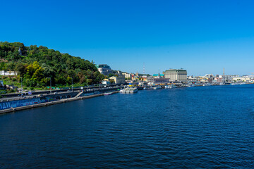 Naklejka na ściany i meble Panoramic view of Podol district and Dnypro river from pedestrian bridge in Kyiv, Ukraine on August 30, 2020. 