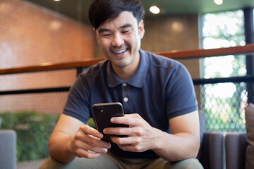 asian man work using cell phone hand holding mobile texting message contact us.chatting,search...