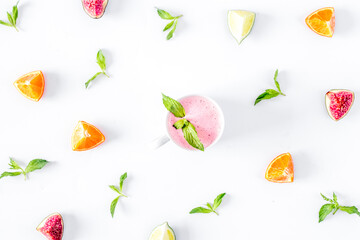 cut fruit pattern with mint and smoothy white desk background top view