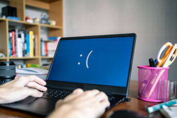 Laptop computer showing its screen with blue screen when it has a system error
