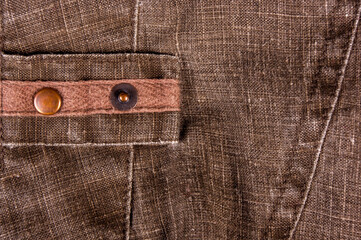 clothing items stonewashed cotton fabric texture with seams, clasps, buttons and rivets, macro
