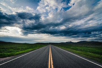 Road heading towards the horizon on a cloudy day. - 419189564