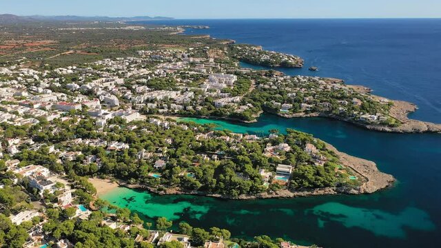 Mallorca, Spain: Aerial view of summer resort town Cala d'Or on Mallorca (Majorca), coast of island and clear waters of Mediterranean Sea - landscape panorama of Balearic Islands from above, Europe