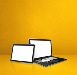 Laptop, mobile phone and digital tablet pc on yellow office desk