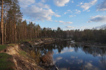 
River with reflection of blue sky and clouds