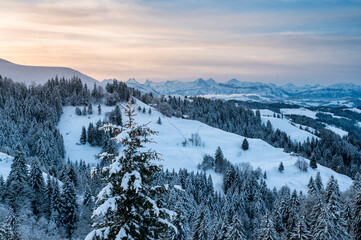 Fototapeta na wymiar view from Lüderenalp over the hills of Emmental on beautiful winter morning in winter