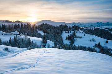 Fototapeta na wymiar view from Lüderenalp over the hills of Emmental on beautiful winter morning in winter