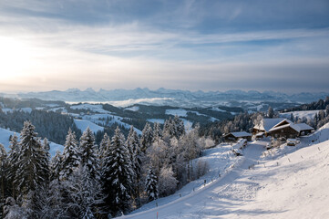 Fototapeta na wymiar view from Lüderenalp over the hills of Emmental on beautiful winter morning