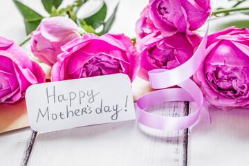 present design with Mother's day text and greeting-card on wooden desk