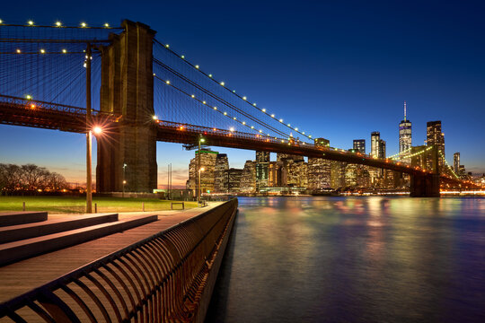 Brooklyn Bridge in evening with the skyscrapers of Lower Manhattan, East River. Brooklyn Bridge Park, New York City, USA
