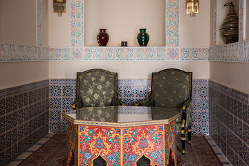 nterior with table and chairs in Egyptian style.