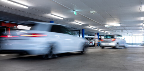 Cars parked in a garage with no people. Many cars in parking garage interior. Underground parking with cars (color toned image)