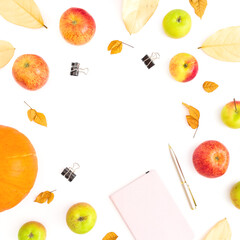Food composition with apple fruit and pumpkin, notebook, pen and clips on white background. Flat lay