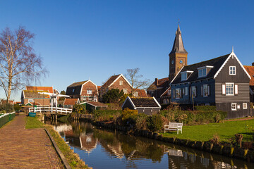 Fototapeta premium Historic Dutch fishing village with colorful wooden houses and church on the former island of Marken on the IJsselmeer in the Netherlands
