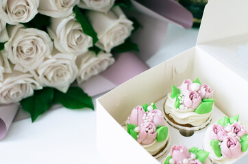 Tender cake with whipped cream. Cake in the form of flowers. Cupcake with whipped cream.