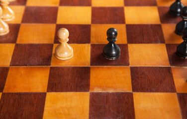 White and black pieces on chess board. Wooden chess.