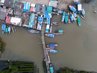 Fototapeta na wymiar Aerial view of fisherman village and mangrove forest in rainy season. 