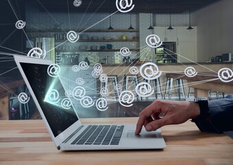 Digital composite image of network of web icons against person using laptop