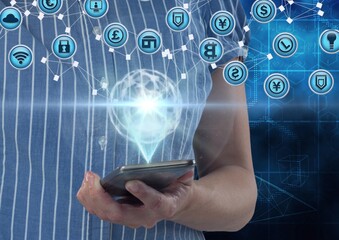 Network of digital icons against mid section of woman holding smartphone