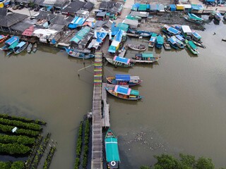 Fototapeta na wymiar Aerial view of fisherman village and mangrove forest in rainy season.
