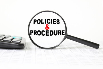 words POLICIES AND PROCEDURE in a magnifying glass on a white background. business concept