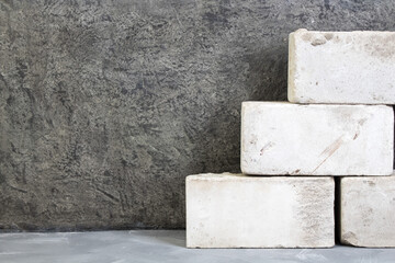 silicate bricks, putty knife on the gray concrete background. Copy space. Top view.
