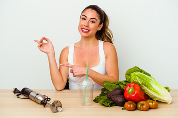 Young caucasian woman preparing a healthy smoothie with vegetables