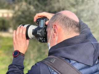 One caucasian male photographer taking pictures of a landmark