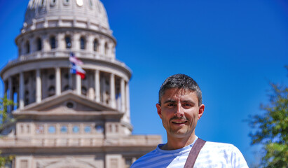Happy male tourist visiting Austin Capitol in spring season