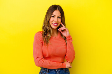 Young caucasian woman isolated on yellow background