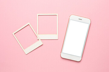 Mobile phone with white screen and moodboard template composition with blank photo cards, torn...