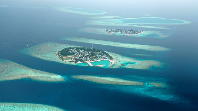 Bird's eye view of tropical islands in the ocean. View of the islands from a drone. Maldives, Thinadhoo (Vaavu Atoll), Dhigurah
