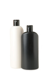 Black and white cosmetic containers isolated on white background. White and black shampoo bottle