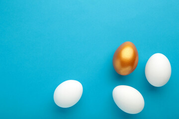 Gold egg with white on blue background