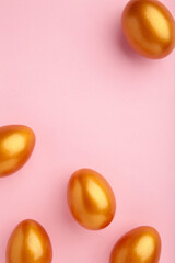 Gold eggs on the pink pastel background. Easter concept.
