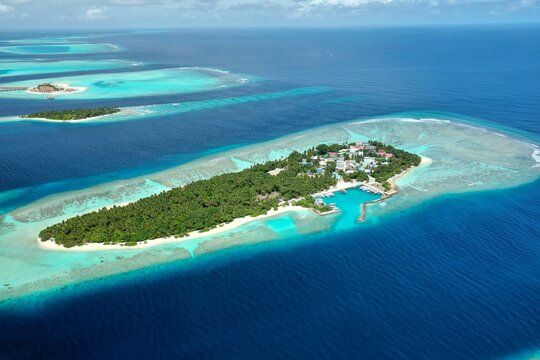 Bird's eye view of tropical islands in the ocean. View of the islands from a drone. Maldives, Thinadhoo (Vaavu Atoll), Dhigurah