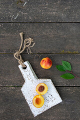 Fresh peaches with leaves on the wooden table close-up. Copy space. High quality photo