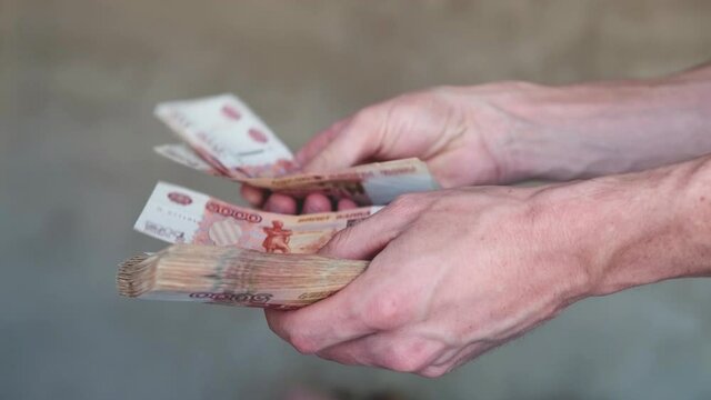Men hands counting money, Russian Ruble currency. financial and wealth concepts. Banknotes in 5000 rubles in male hands. Investment, Save money . Mortgage concept