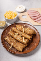 Pancakes on a plate with ham and cheese