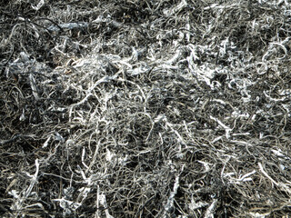 Background from the ashes of the burnt grass. Plant ash on the field after the fire burned. Abstract background texture