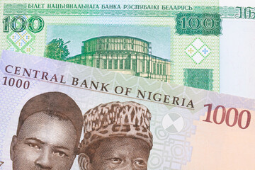 A macro image of a blue, purple and green one thousand  naira note from Nigeria paired up with a green one hundred ruble note from Belarus.  Shot close up in macro.
