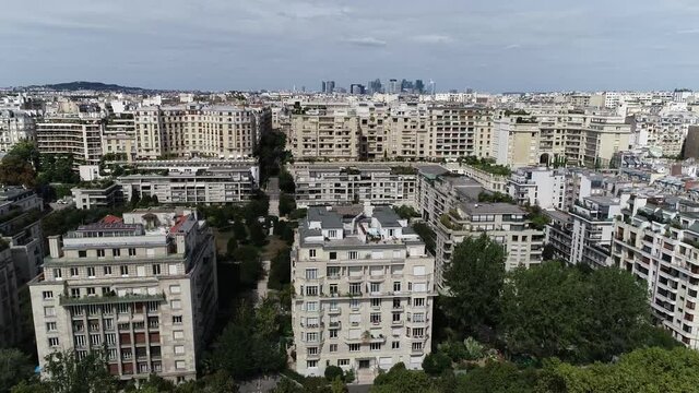 Low altitude aerial view of the 16th arrondissement of Paris is one of the 20 arrondissements of the capital city of France showing La Defense neighbourhood in background 4k high resolution footage